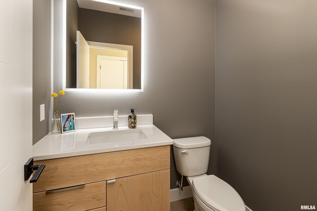 bathroom with vanity, visible vents, and toilet