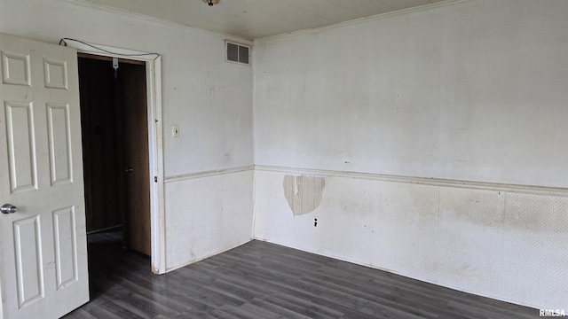 205 Shaw St, Harrisburg, IL 62946 - empty room with crown molding, visible vents, and dark wood finished floors