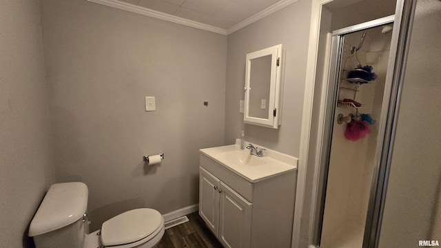 205 Shaw St, Harrisburg, IL 62946 - full bath with vanity, ornamental molding, toilet, a shower stall, and wood finished floors
