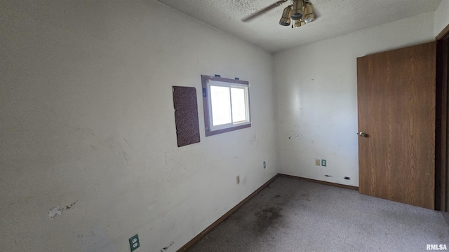 205 Shaw St, Harrisburg, IL 62946 - empty room with baseboards, ceiling fan, a textured ceiling, carpet flooring, and lofted ceiling