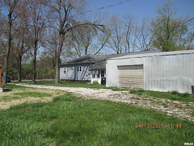 229 S James St, Centralia, IL 62801 - exterior space featuring dirt driveway and an attached garage