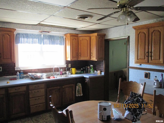 229 S James St, Centralia, IL 62801 - kitchen with a ceiling fan, visible vents, light countertops, a sink, and decorative backsplash