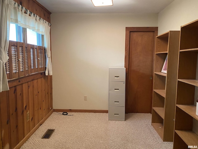 carpeted empty room featuring visible vents and baseboards