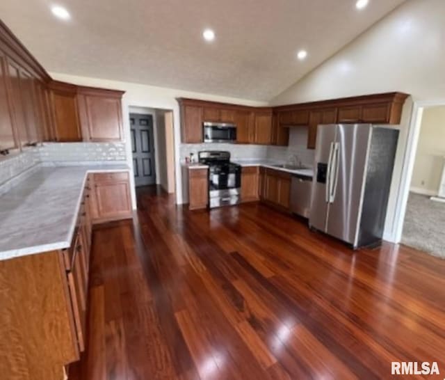 kitchen with recessed lighting, dark wood-style floors, light countertops, decorative backsplash, and appliances with stainless steel finishes