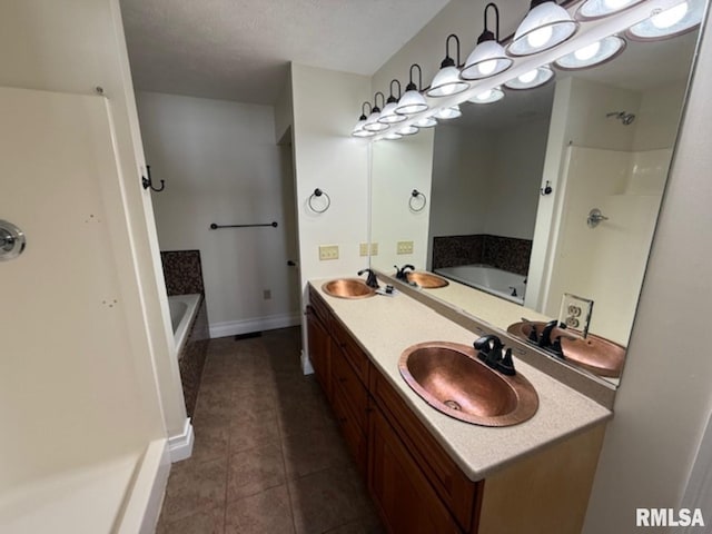 bathroom featuring a bath, a sink, and tile patterned floors