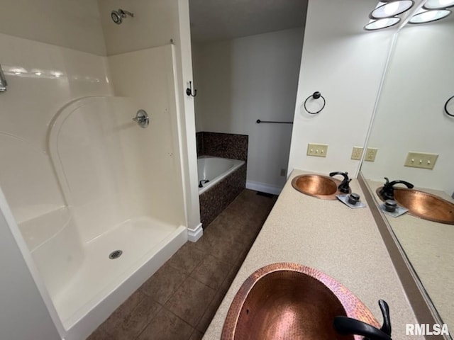 full bathroom with a bath, baseboards, vanity, tile patterned floors, and a stall shower