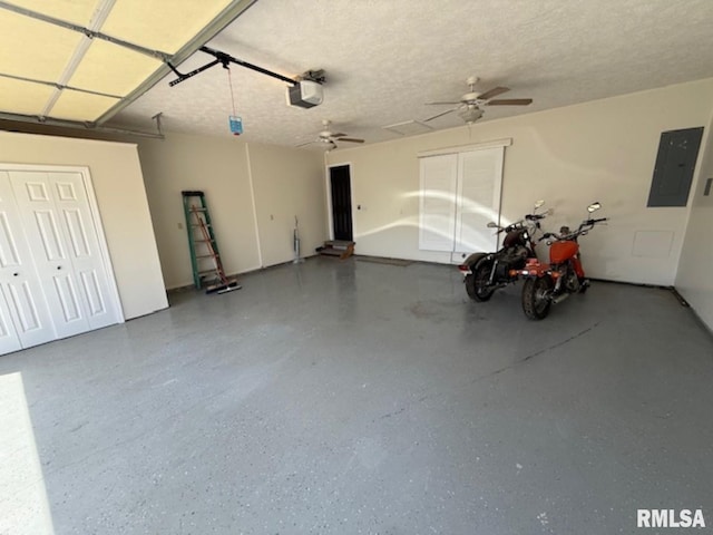 garage featuring electric panel, a garage door opener, and ceiling fan