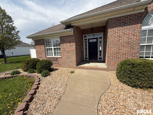 property entrance featuring brick siding