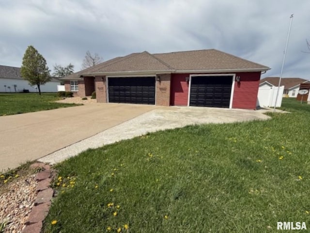 exterior space with an attached garage, concrete driveway, and a front lawn