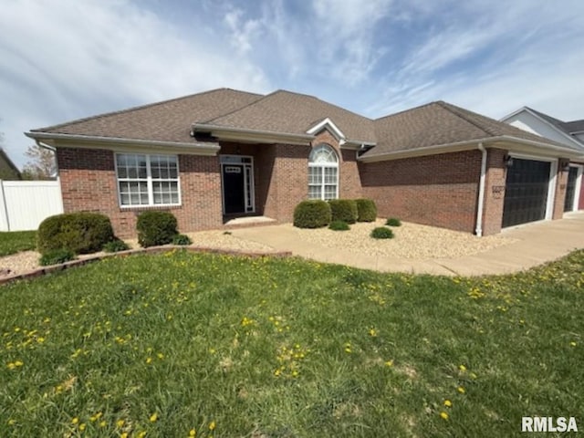 view of front of house with concrete driveway, an attached garage, a front yard, brick siding, and fence