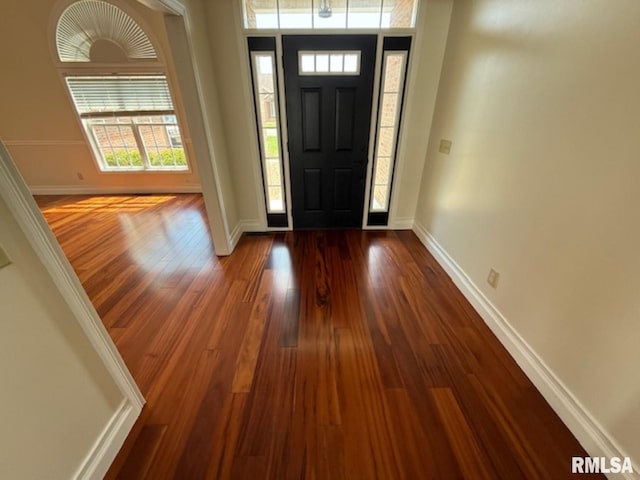 entryway featuring dark wood-style floors and baseboards