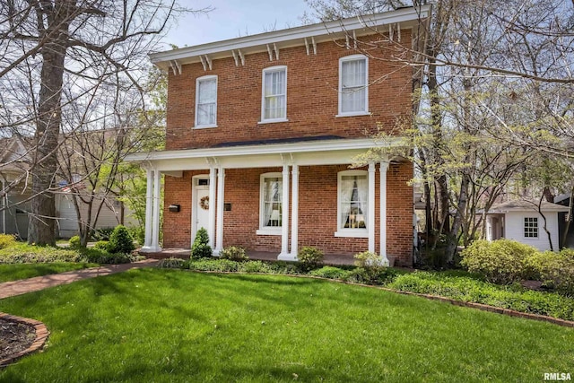 italianate house with a porch, a front yard, and brick siding