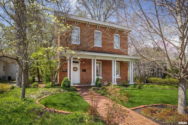 italianate house featuring brick siding, a front lawn, cooling unit, and covered porch