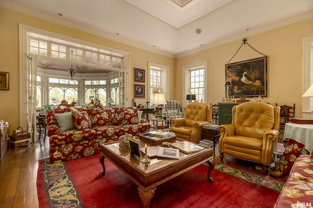 living area with ornamental molding and hardwood / wood-style floors