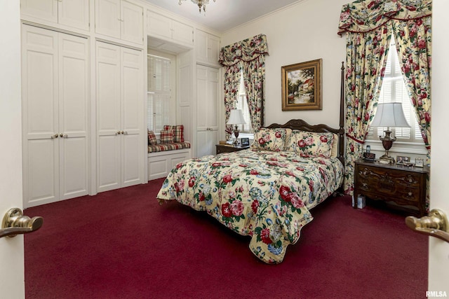 bedroom featuring crown molding and dark colored carpet