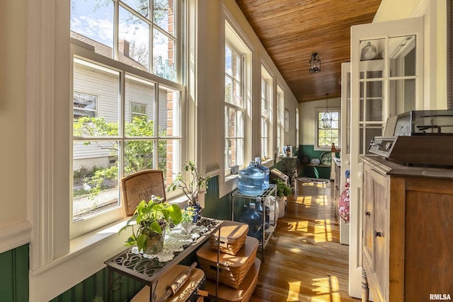 sunroom / solarium featuring wood ceiling, vaulted ceiling, and wood finished floors