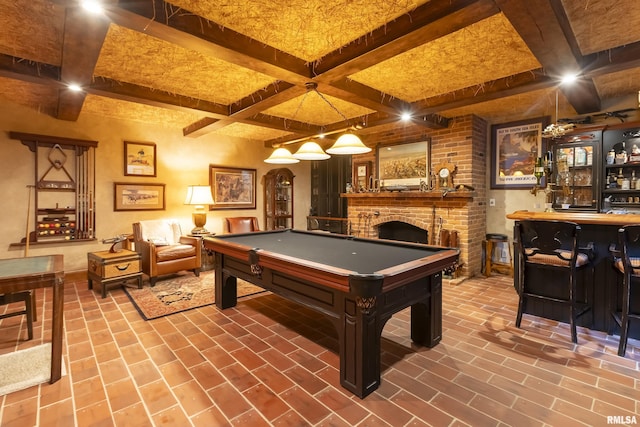 recreation room with billiards, a brick fireplace, beam ceiling, coffered ceiling, and brick floor