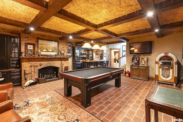 playroom with beamed ceiling, a brick fireplace, coffered ceiling, brick floor, and billiards