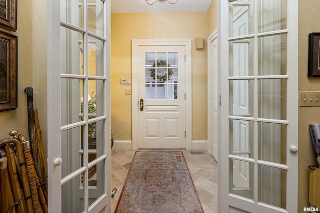 entryway featuring french doors and baseboards