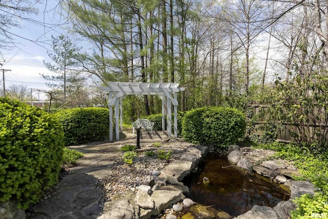 view of yard with a pergola and fence