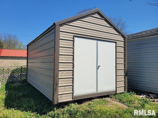 view of shed featuring fence