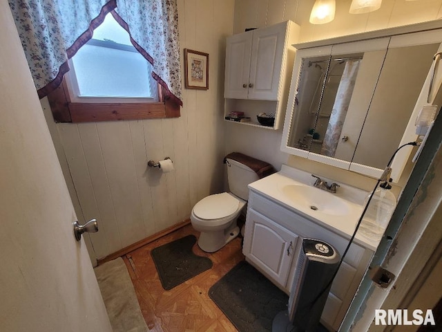bathroom with toilet and vanity