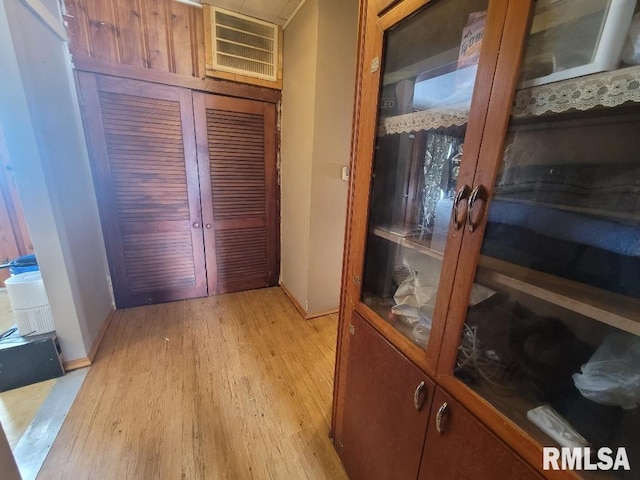hallway featuring baseboards and light wood-style floors