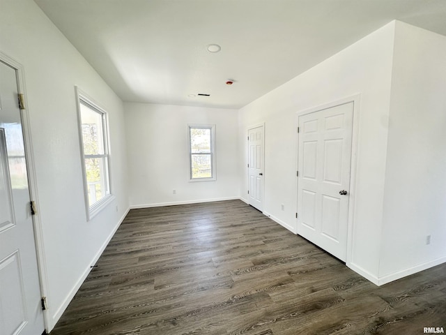 641 N Hickory St, Centralia, IL 62801 - unfurnished bedroom with baseboards and dark wood-style floors
