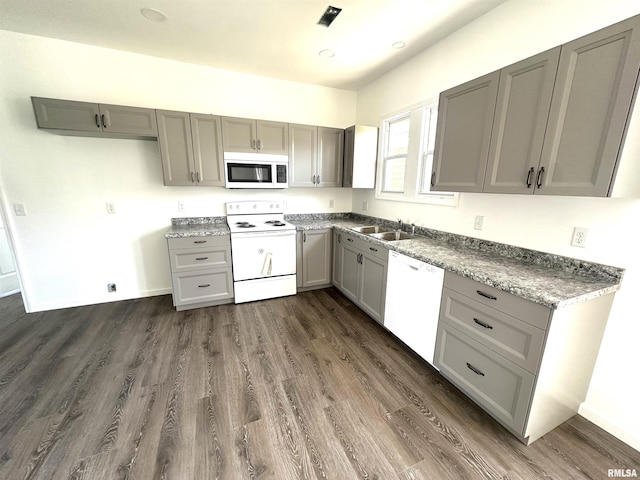 641 N Hickory St, Centralia, IL 62801 - kitchen featuring recessed lighting, a sink, dark wood-type flooring, white appliances, and gray cabinetry