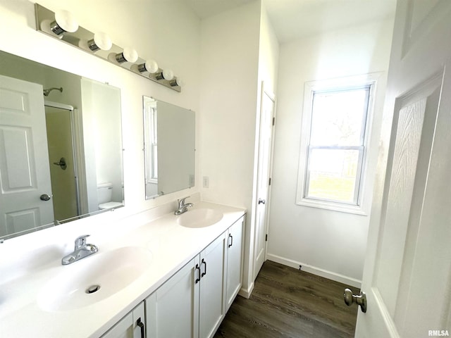 641 N Hickory St, Centralia, IL 62801 - bathroom with wood finished floors, a sink, double vanity, and toilet