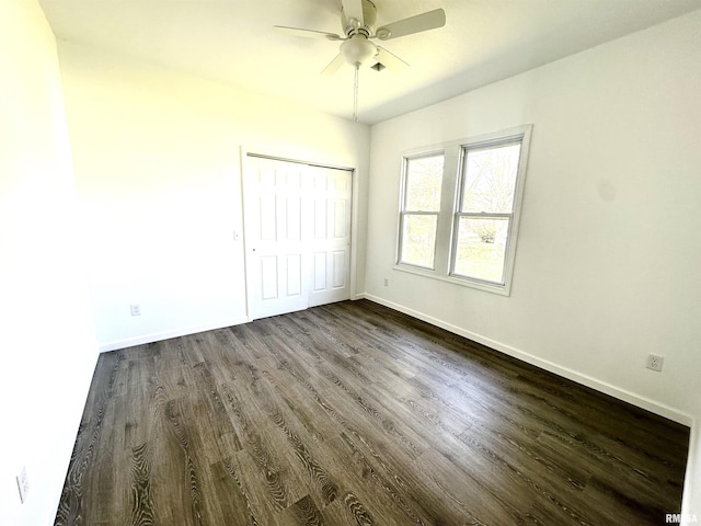 641 N Hickory St, Centralia, IL 62801 - unfurnished bedroom with baseboards, a closet, dark wood-style floors, and ceiling fan