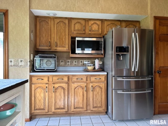 3 Suburban Dr, Murphysboro, IL 62966 - kitchen featuring brown cabinets, light tile patterned floors, appliances with stainless steel finishes, and light countertops