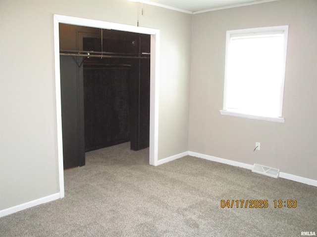 205 Texas St, Carterville, IL 62918 - unfurnished bedroom featuring baseboards, visible vents, carpet floors, and a closet