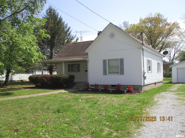 205 Texas St, Carterville, IL 62918 - bungalow with an outbuilding, driveway, a shingled roof, and a front yard