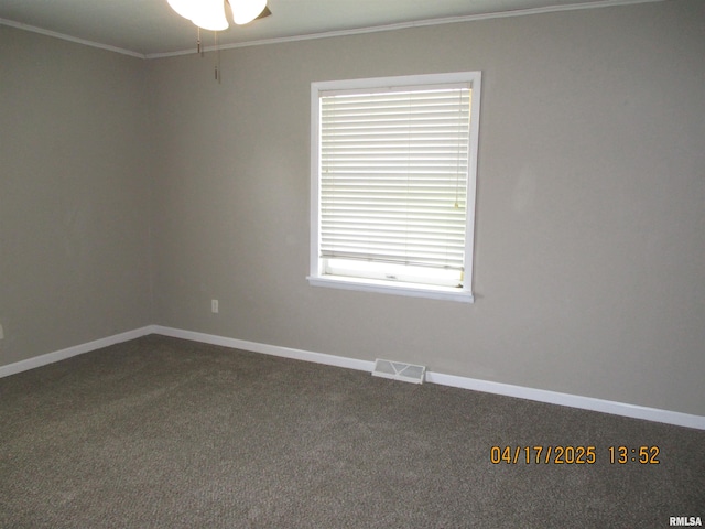 205 Texas St, Carterville, IL 62918 - unfurnished room with baseboards, dark colored carpet, visible vents, and crown molding