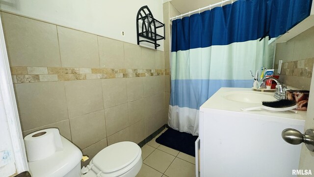 809 N 12th St, Herrin, IL 62948 - bathroom with tile patterned floors, toilet, tile walls, curtained shower, and vanity