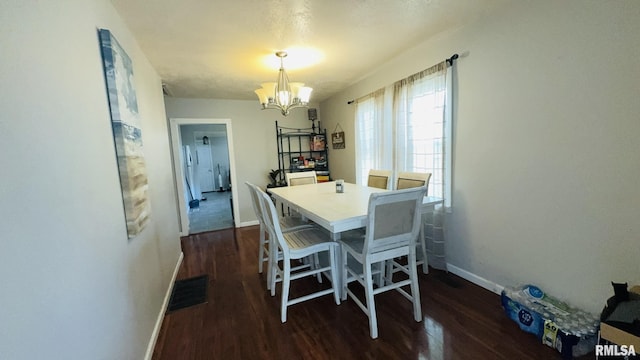 809 N 12th St, Herrin, IL 62948 - dining space with baseboards, visible vents, a chandelier, and dark wood-style floors