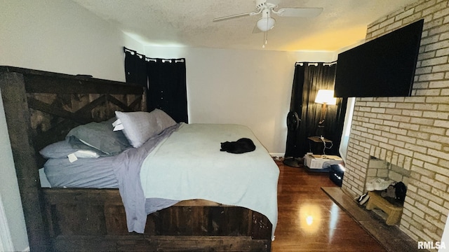 809 N 12th St, Herrin, IL 62948 - bedroom with a ceiling fan, wood finished floors, a textured ceiling, and a fireplace
