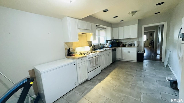 809 N 12th St, Herrin, IL 62948 - kitchen featuring backsplash, light countertops, white appliances, and white cabinetry