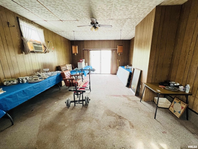 bedroom featuring cooling unit, wooden walls, and carpet floors