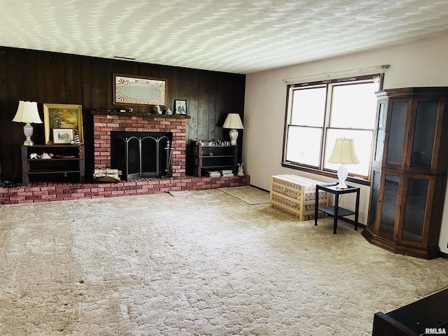 carpeted living room with a fireplace and wooden walls