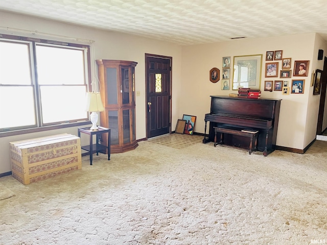 living area featuring carpet flooring and baseboards