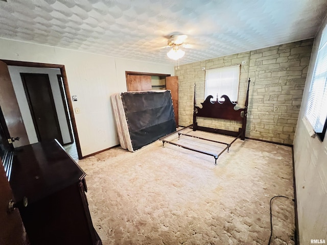 bedroom with a ceiling fan and baseboards