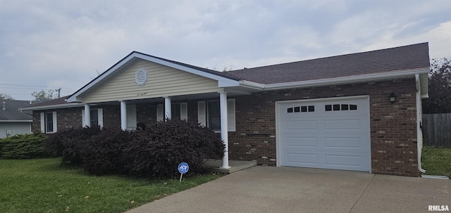 214 W Locust St, Harrisburg, IL 62946 - ranch-style house with a front lawn, driveway, a porch, a garage, and brick siding