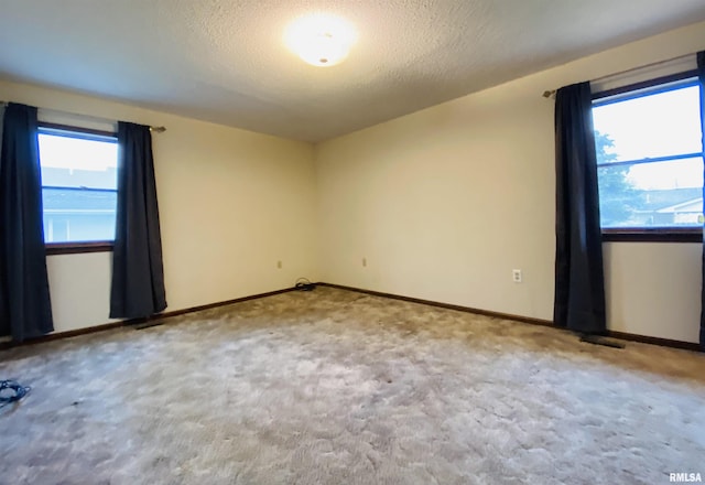 214 W Locust St, Harrisburg, IL 62946 - carpeted spare room featuring a textured ceiling and baseboards