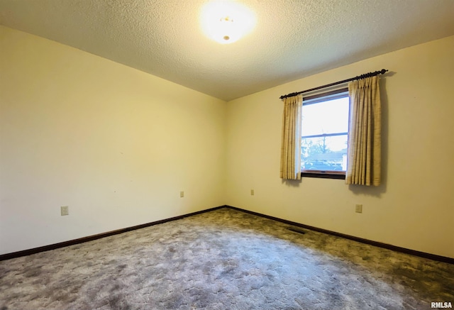 214 W Locust St, Harrisburg, IL 62946 - empty room featuring baseboards, a textured ceiling, visible vents, and carpet