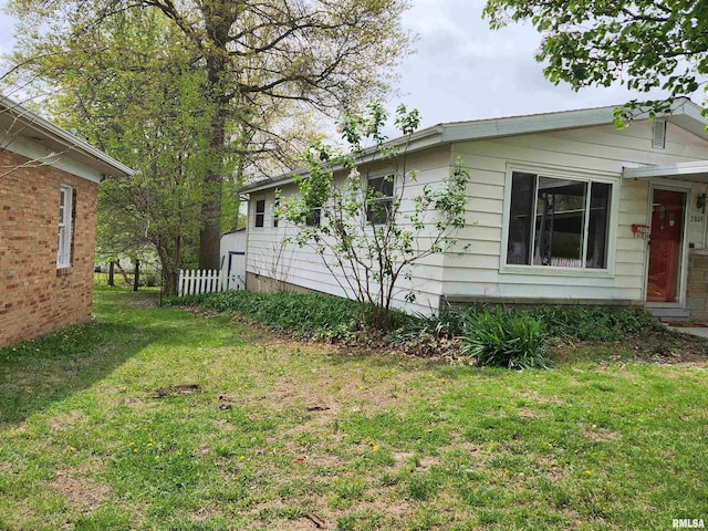 view of home's exterior with a yard