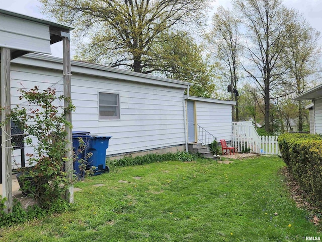 view of yard featuring entry steps and fence