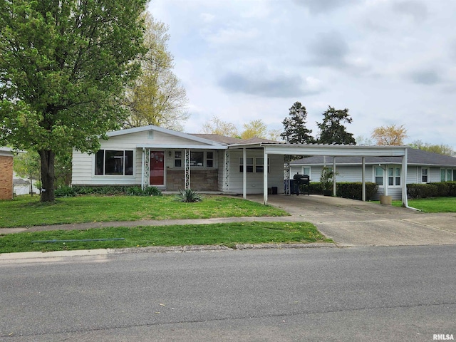 ranch-style house featuring a carport, driveway, and a front yard