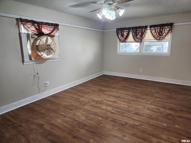 spare room with baseboards, wood finished floors, a textured ceiling, and ceiling fan